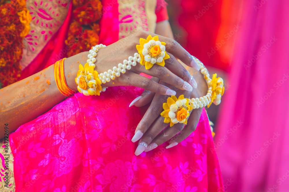 Indian pre wedding haldi ceremony ritual items, decorations and hands close up