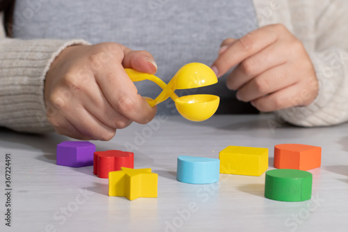 hand playing with tweezers 
