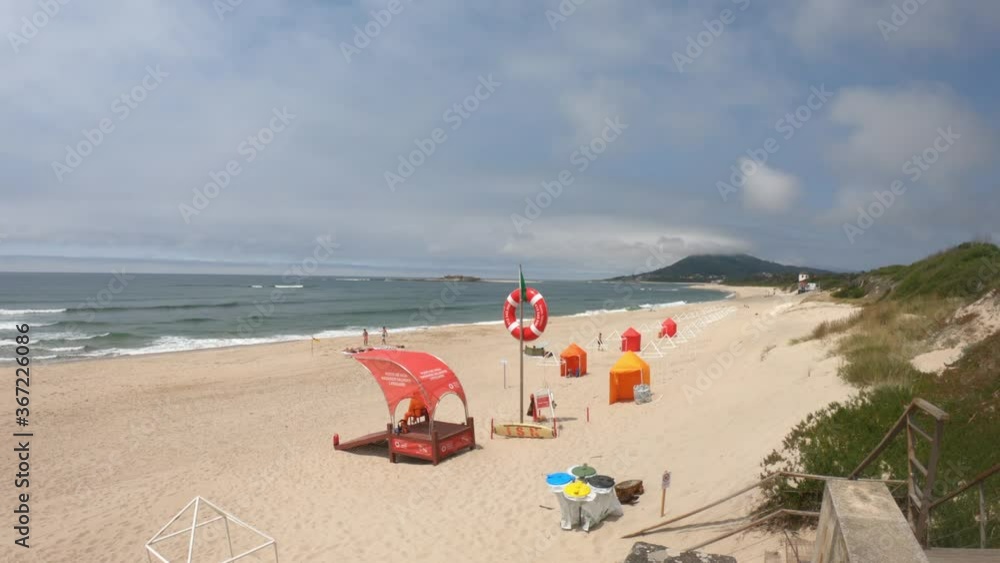 Moledo / Caminha / Portugal - July 8, 2020: The Praia de Moledo Beach. It's an Oceanic Beach in the northern hemisphere bathed by the Atlantic Ocean. Lifeguard lookout post, with big red lifebuoy.