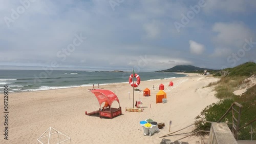 Moledo / Caminha / Portugal - July 8, 2020: The Praia de Moledo Beach. It's an Oceanic Beach in the northern hemisphere bathed by the Atlantic Ocean. Lifeguard lookout post, with big red lifebuoy. photo