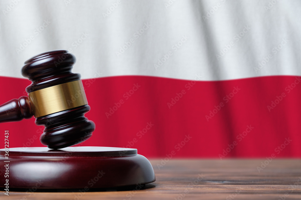 Justice and court concept in Republic of Poland. Judge hammer on a flag background Justice and court concept in Republic of Poland. Judge hammer on a flag background
