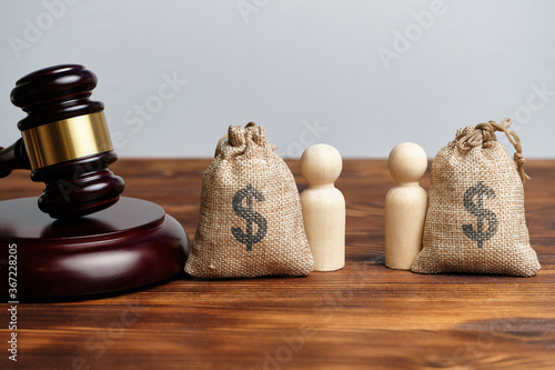 The concept of the division of property in business between owners next to the judge hammer