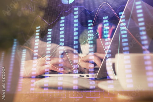 Double exposure of woman hands typing on computer and forex chart hologram drawing. Stock market invest concept.