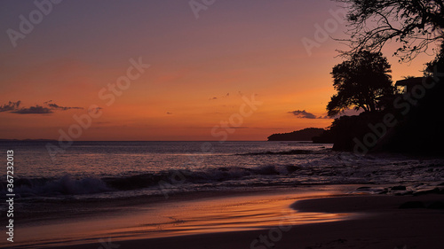 Tree silhouette against amazing sunset over the ocean on Contadora island, Panama