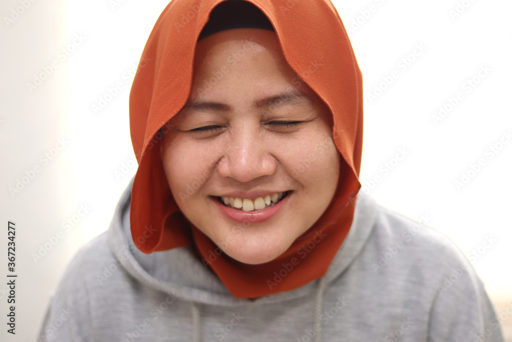 Portrait of beautiful muslim woman wearing hijab smiling shy Portrait of beautiful muslim woman wearing hijab smiling shy