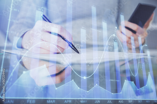 Double exposure of forex chart sketch hologram and woman holding and using a mobile device. Financial market concept.