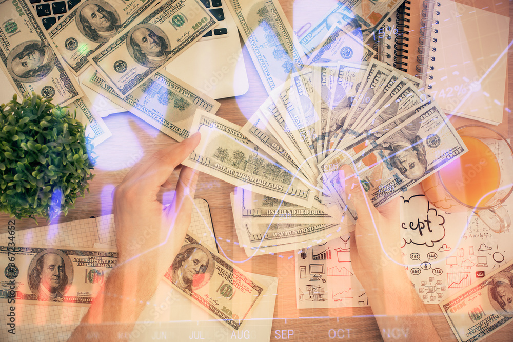 Multi exposure of financial graph drawing hologram and USA dollars bills and man hands. Analysis concept. Multi exposure of financial graph drawing hologram and USA dollars bills and man hands. Analysis concept.