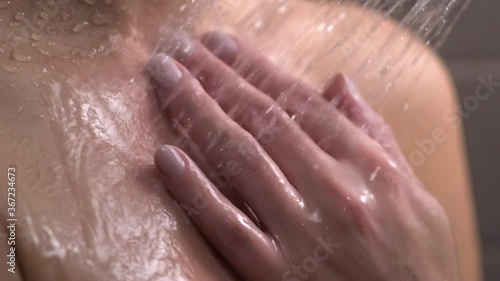 Wallpaper Mural A woman in the shower. A close-up of the woman's hand. Water droplets slowly fall on the skin. Hygiene, skin care. Torontodigital.ca