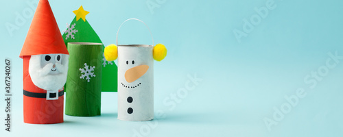 Merry christmas toy collection santa claus, snowman, tree on blue for Winter holiday concept background. Paper crafts, DIY. creative idea from toilet roll tube, banner