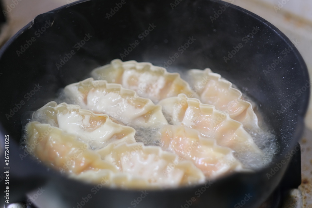 close up cooking fried dumpling in pot. traditional Chinese food. soft focus close up cooking fried dumpling in pot. traditional Chinese food. soft focus