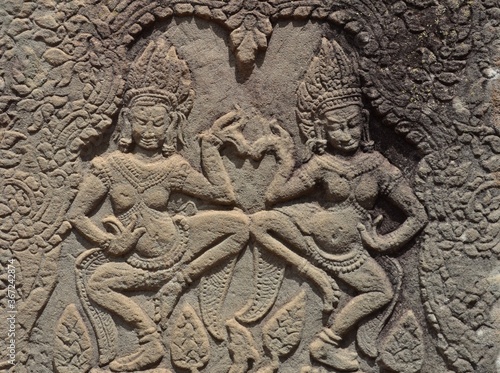 Ancient wall detail of two dancing deities at Bantaey Srey Temple, Siem Reap, Cambodia