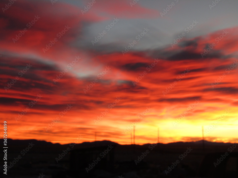 Dramatic red and gold sunset reflecting off of the clouds in the mountains. Dramatic red and gold sunset reflecting off of the clouds in the mountains.