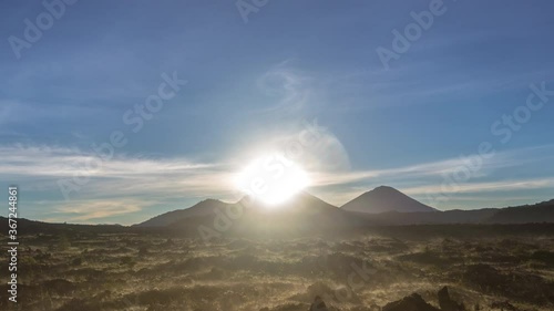 sunrise in kintamani. volcano Batur Bali Indonesiai. caldera view. unesco. Fast clouds moving. Timelapse hyperlapse 4K video. black lava. vulcano Abang Agung photo