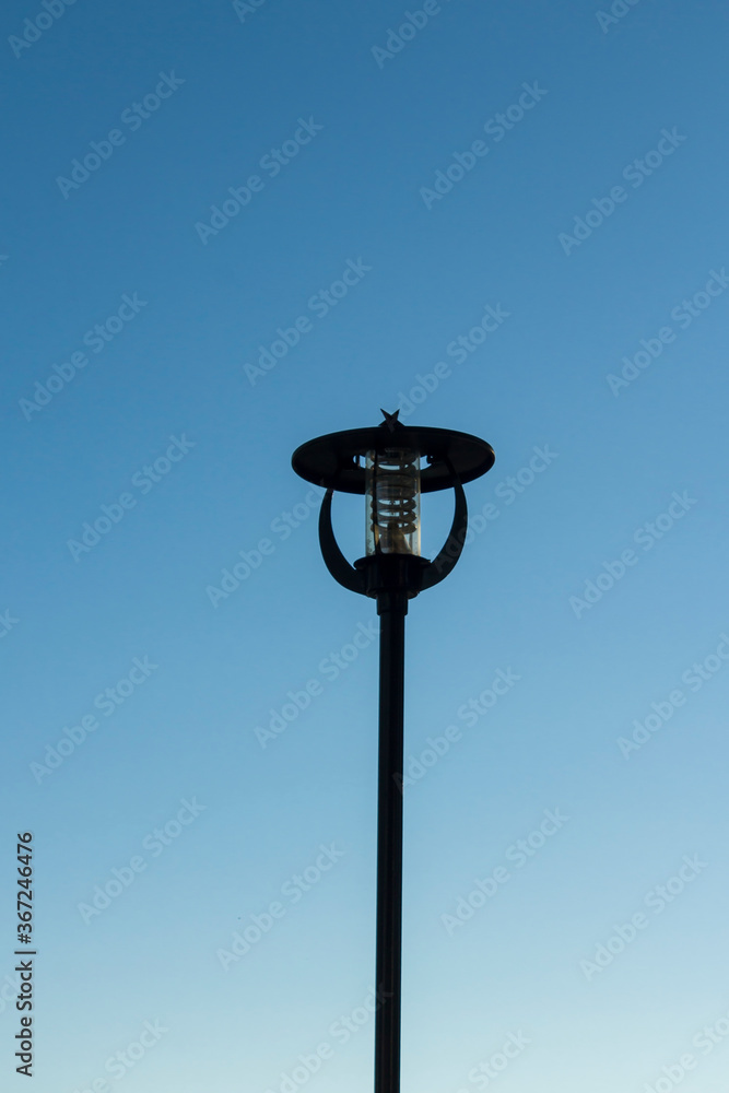 Black color.metal moon star shaped street lamp on blue,close up taken. Black color.metal moon star shaped street lamp on blue,close up taken.