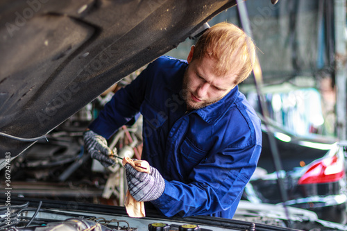 Male auto mechanic working at the repair shop.