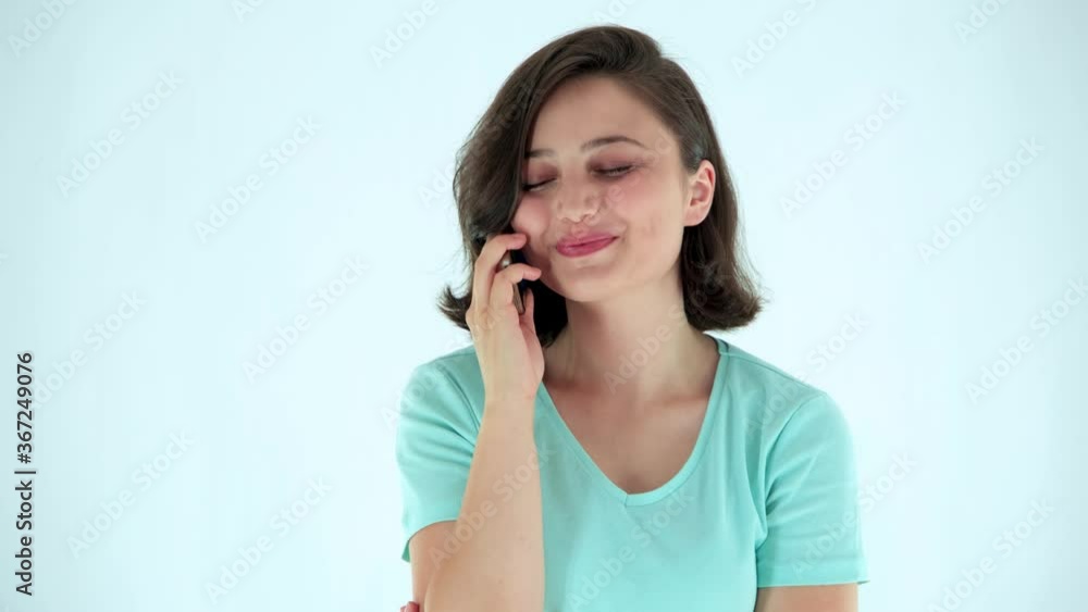 Portrait of a beautiful girl talking on the phone. Indoor studio shot on isolated background. People, lifestyle, mobile communication concept. Portrait of a beautiful girl talking on the phone. Indoor studio shot on isolated background. People, lifestyle, mobile communication concept.