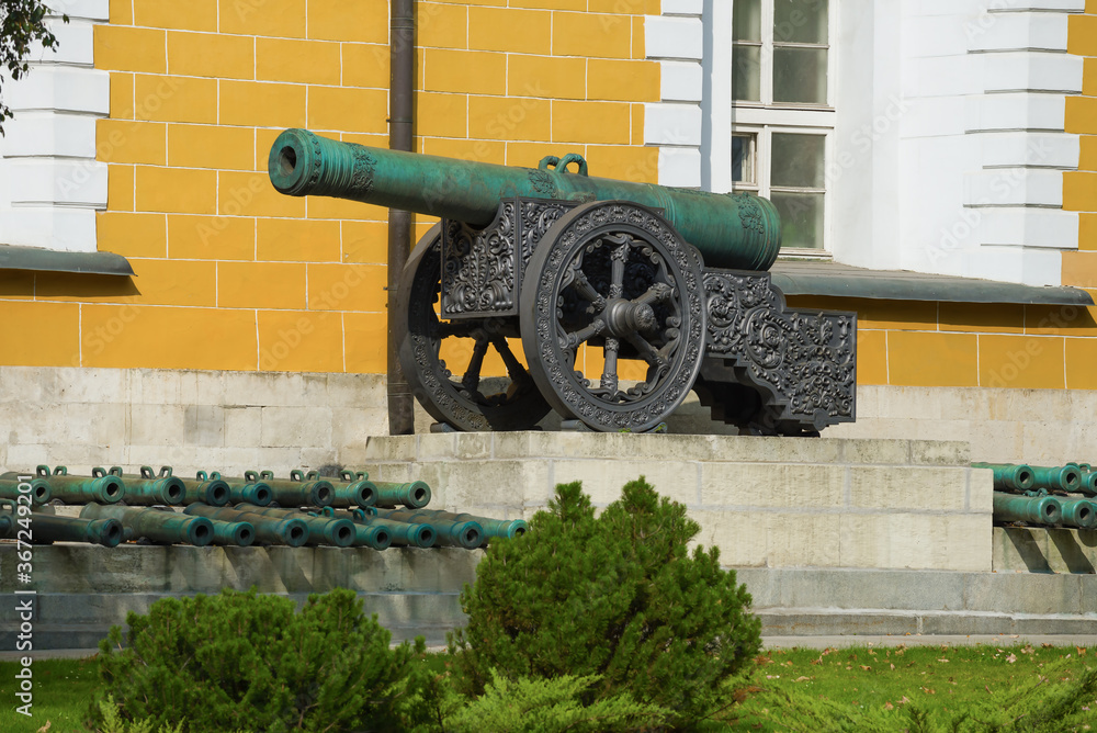 Ancient cannon near the walls of the Arsenal building on a sunny day. Moscow Kremlin, Russia Ancient cannon near the walls of the Arsenal building on a sunny day. Moscow Kremlin, Russia