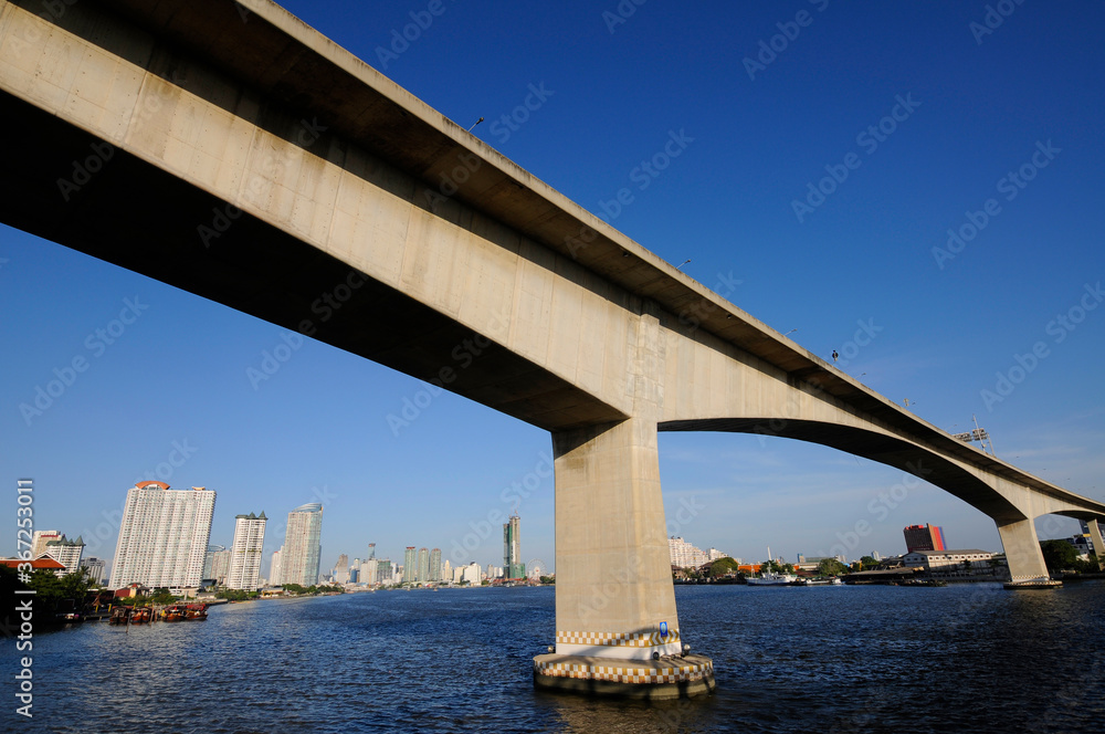 concrete bridge across the river in the city with blue sky concrete bridge across the river in the city with blue sky