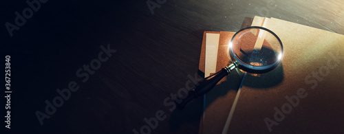 (3D Rendering, illustration) Magnifying glass and some paper folders on a table