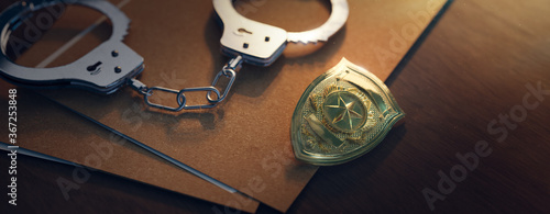 Quadro em tela Police officer badge with handcuffs on a dark background ( 3D rendering, illustr