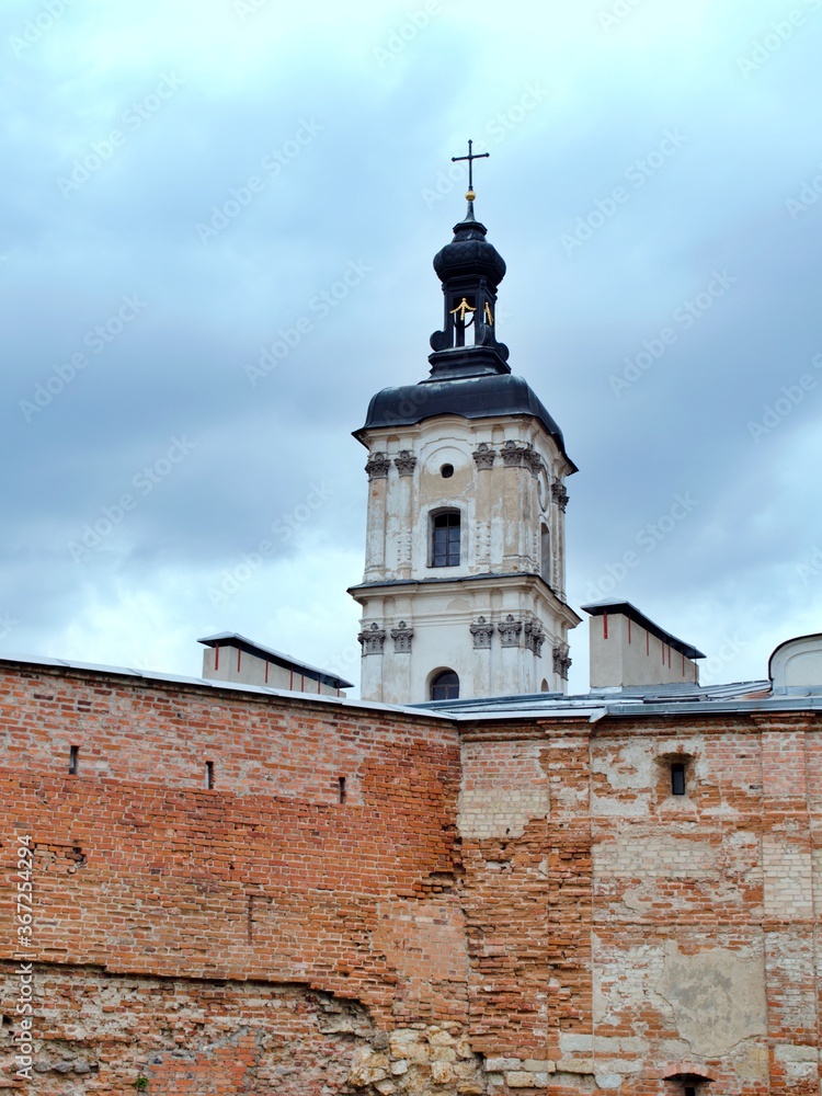catholic cathedral tower behind fortress wall