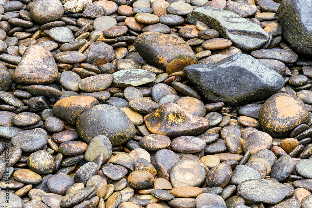 Close up view of smooth polished multicoloured stones decorate in the park Close up view of smooth polished multicoloured stones decorate in the park