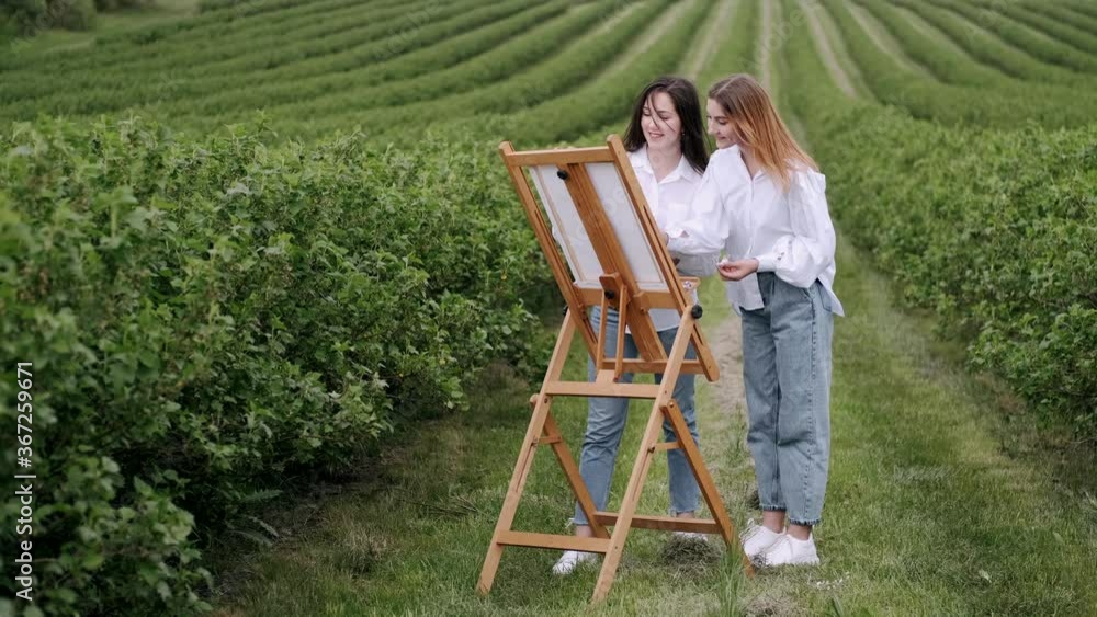 Women in a summer field. Cute lady drawing. Girl in a white shirt. Women in a summer field. Cute lady drawing. Girl in a white shirt.