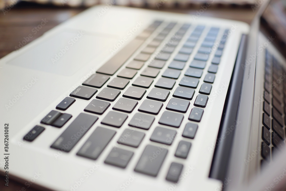 Closeup of a silver and black laptop keyboard. 