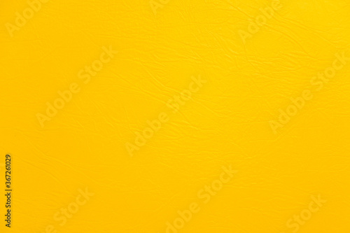 Texture of yellow leather surface, fabric for sewing furniture and other products.