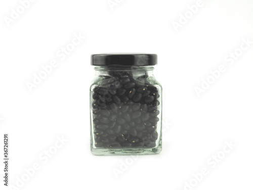Black gram (vigna mungo) in a glass bottle with lid isolated on a white background. High vitamins and iron. Healthy nutrition food concept..