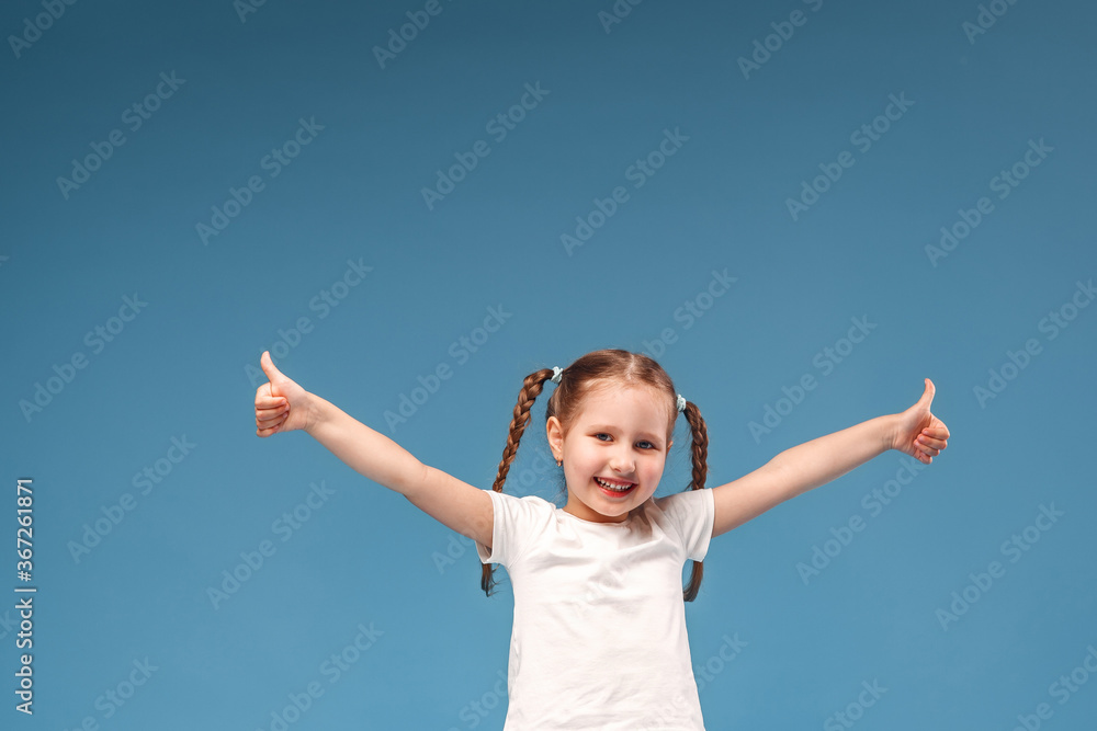little girl with pigtails in a white t-shirt shows gesture of approval to class little girl with pigtails in a white t-shirt shows gesture of approval to class