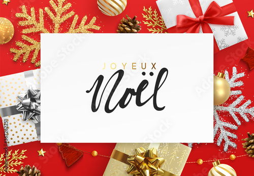 French text Joyeux Noel. Christmas and New Year background. Decoration realistic gift box, green pine branches, gold balls, decorative snowflake in glitter and tinsel. Xmas bauble. Holiday design.