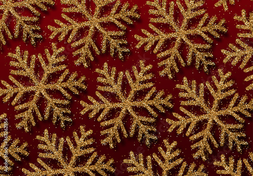 Background golden snowflakes strewn with bright sparkles. Winter festive pattern. Glitter gold snowflakes texture. Christmas backdrop. Xmas decoration. vector illustration