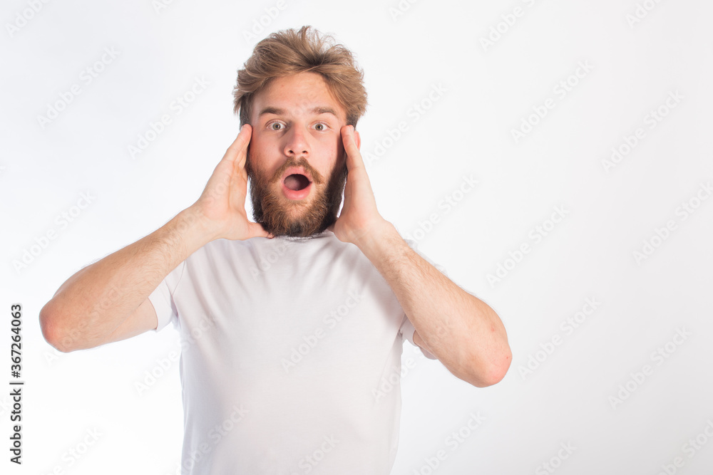portrait of a young guy with rusty hair and tanned skin who is fooling around on camera. space for text. isolate on a white background portrait of a young guy with rusty hair and tanned skin who is fooling around on camera. space for text. isolate on a white background