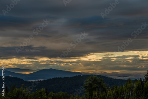 View for valley under Mittagskogel hill in summer cloudy morning