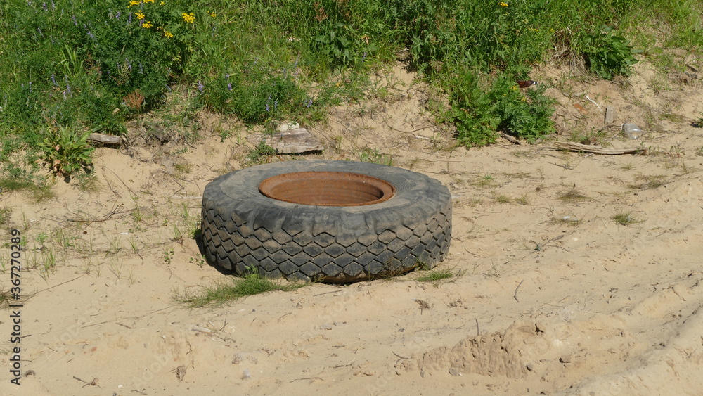 the old wheel of the car. A violation of ecology