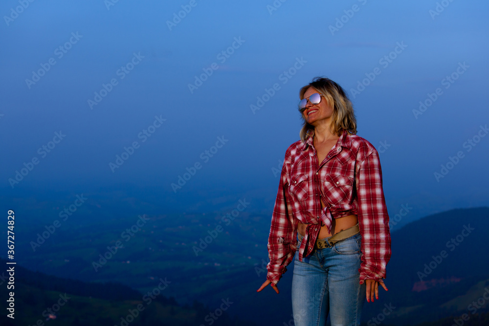 girl posing against the backdrop of a mountain girl posing against the backdrop of a mountain