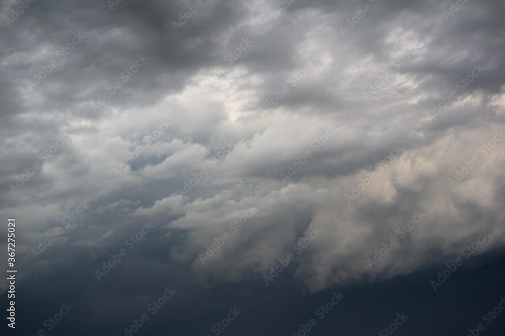 Cloudy and overcast dramatic sky. Dark and bright clouds. Beautiful nature, landscape and cloudscape scenery. 