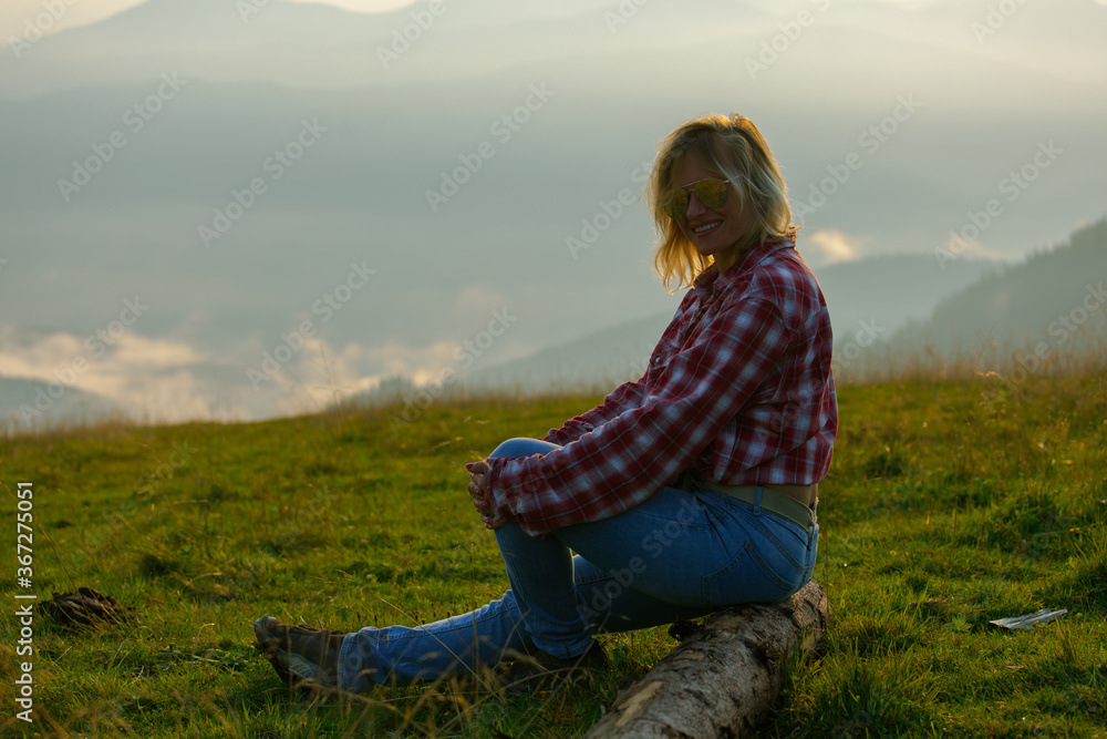 blonde woman in the foggy mountains