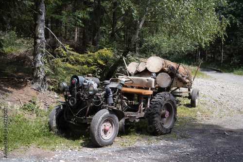 Old retro and vintage home-made tractor. Rustic vehicle for lumberjack and woodman work in the wood and forest. 