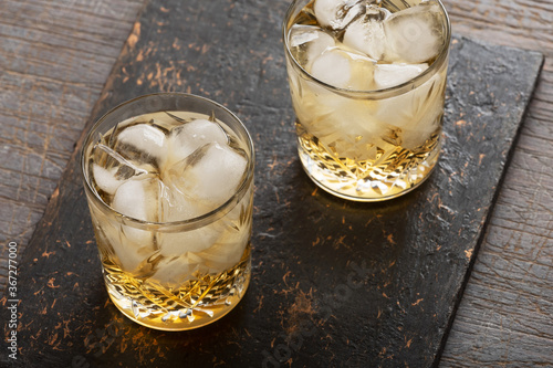 Whiskey with ice in an old fashioned glass.