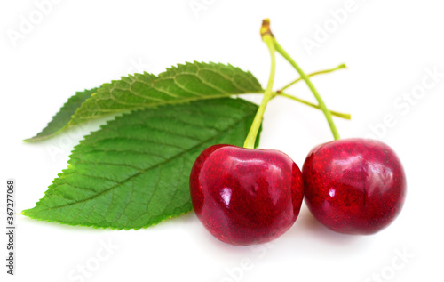 Sweet cherries with stem and leaves.