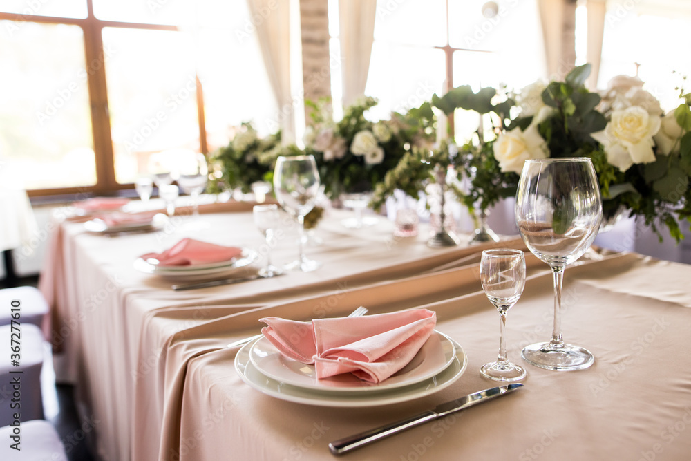 Fototapeta premium Close up of festive table setting with empty wine glasses