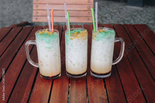 Es Cendol, Java traditional drink. Cendol is an iced sweet popular dessert that contains droplets of worm-like green rice flour jelly, coconut milk and palm sugar syrup photo