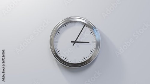 Glossy chrome clock on a white wall at five past three. Time is 03:05 or 15:05