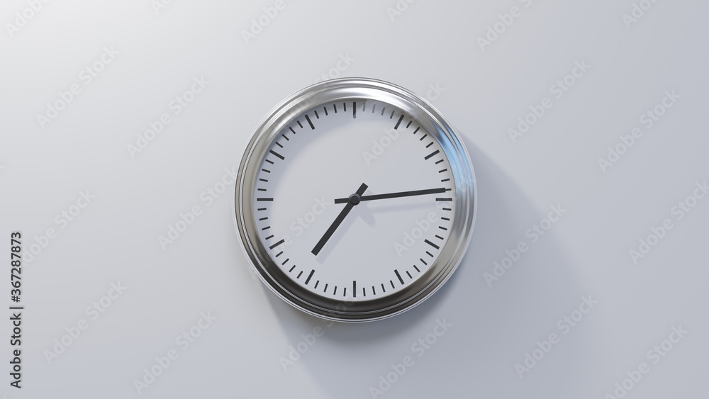 Glossy chrome clock on a white wall at fourteen past seven. Time is 07:14 or 19:14 Glossy chrome clock on a white wall at fourteen past seven. Time is 07:14 or 19:14