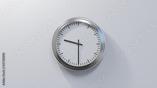 Glossy chrome clock on a white wall at half past nine. Time is 09:30 or 21:30