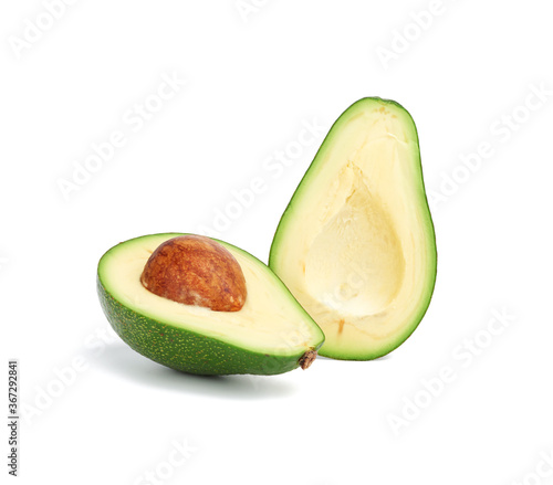 half ripe green avocado with a brown stone isolated on a white background