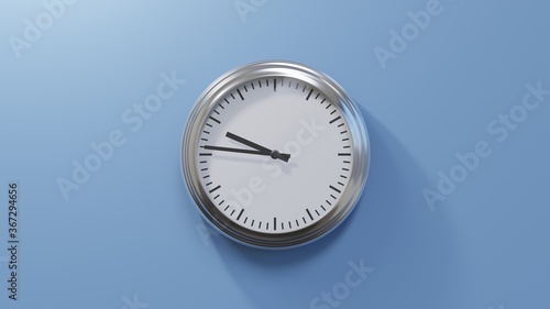 Glossy chrome clock on a blue wall at forty-six past nine. Time is 09:46 or 21:46