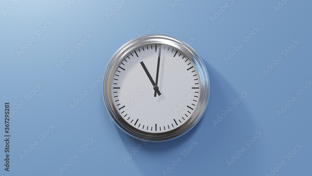 Glossy chrome clock on a blue wall at one past eleven. Time is 11:01 or 23:01 Glossy chrome clock on a blue wall at one past eleven. Time is 11:01 or 23:01